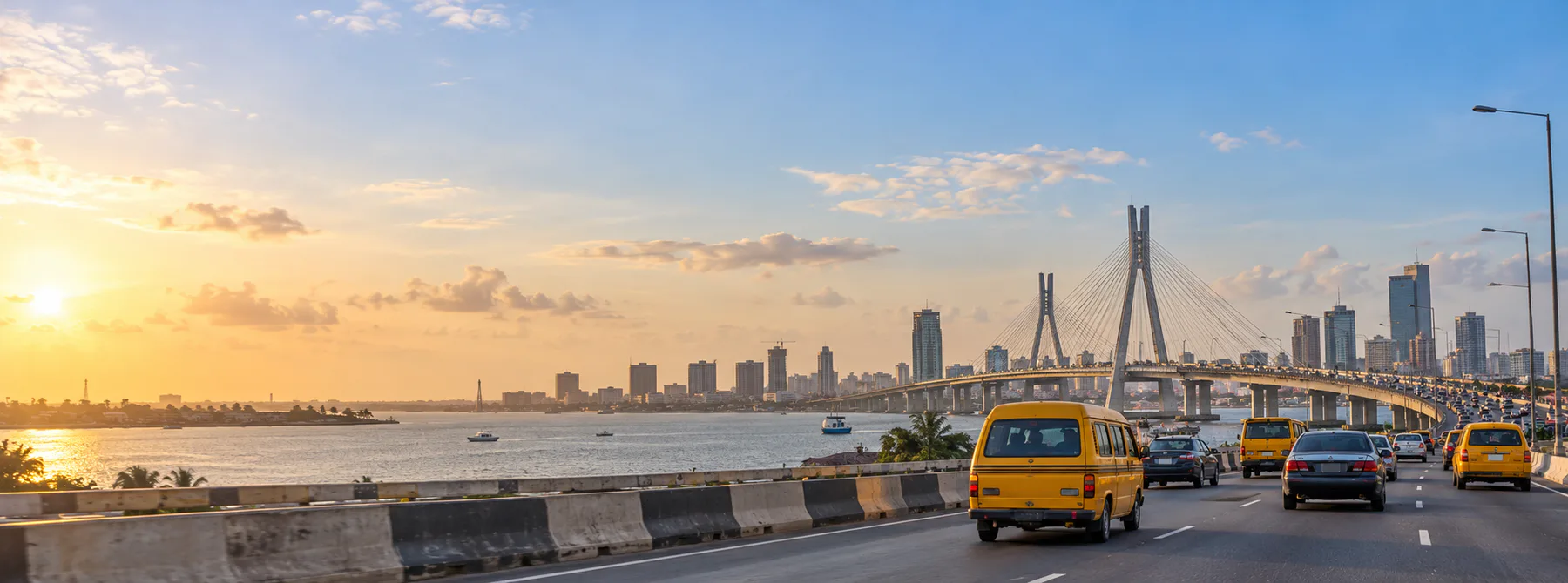 Illustrative Lagos road with vehicles and a bridge in the distance